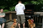 Chris cooking on the bbq while the dogs watch.